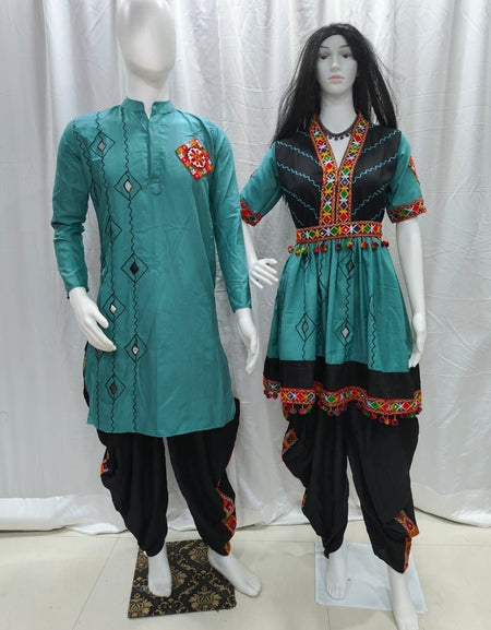 A traditional Indian Couple wear matching outfit displayed on two mannequins, featuring a teal long kurta with black harem pants on the left, and a matching teal and black tunic with a flared skirt and embroidered borders on the right.