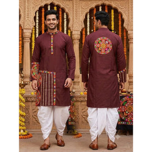 A man modeling a traditional maroon kurta with colorful embroidery, shown from both front and back views, paired with white dhoti pants and brown shoes in front of an ornate stone archway decorated with marigold garlands.