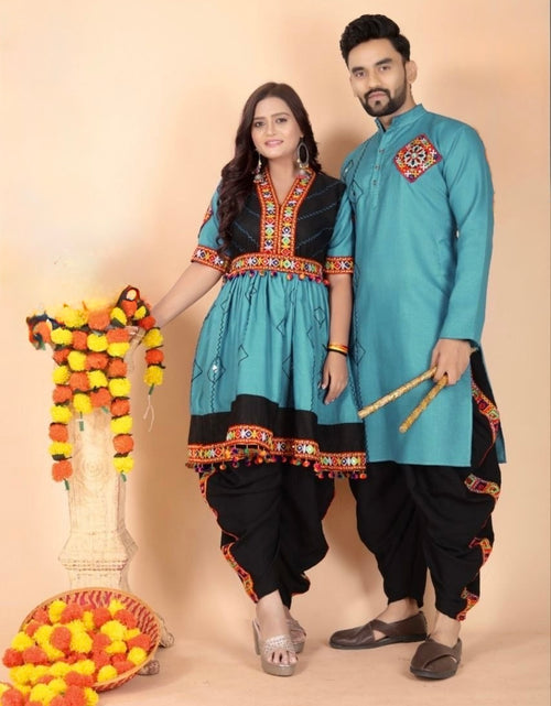 Load image into Gallery viewer, A man and a woman modeling matching ethnic wear against a solid beige studio background. The woman wears a turquoise and black kurta set with ornate embroidery, paired with black pants, while the man wears a matching turquoise kurta with a red embroidered chest motif and black pants.
