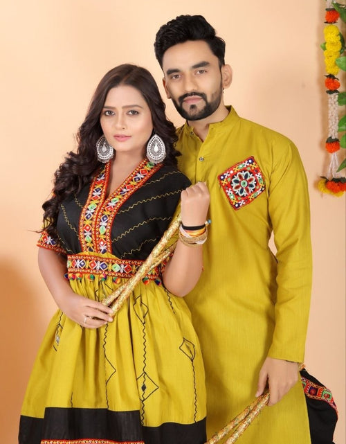 Load image into Gallery viewer, A couple posing in traditional Indian couple wear matching Navratri ethnic wear. The woman wears a yellow and black embroidered kurta and Dhoti set, while the man wears a solid yellow kurta and black dhoti
