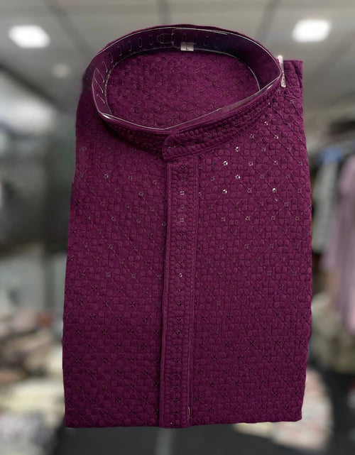 Load image into Gallery viewer, A folded wine textured kurta shirt with a mandarin collar, displayed against a blurred background.
