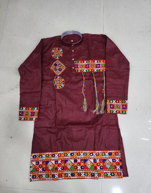 Load image into Gallery viewer, A maroon long-sleeve kurta with colorful geometric embroidery and tassels, laid flat on a light-colored tiled floor.

