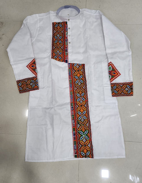 Load image into Gallery viewer, A white long-sleeve kurta laid flat on a light beige tiled floor, featuring colorful geometric embroidered patterns in red, orange, blue, and green along the center placket, cuffs, and collar.
