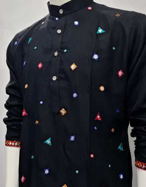 Load image into Gallery viewer, A black long-sleeve kurta displayed on a white mannequin, featuring colorful geometric embroidered motifs in red, blue, orange, and green, with a mandarin collar and buttoned front.
