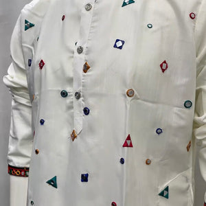 A white long-sleeve kurta with colorful geometric embroidered motifs, displayed on a mannequin torso against a plain light gray background.