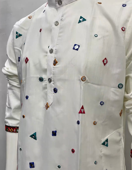 A white long-sleeve kurta with colorful geometric embroidered motifs, displayed on a mannequin torso against a plain light gray background.