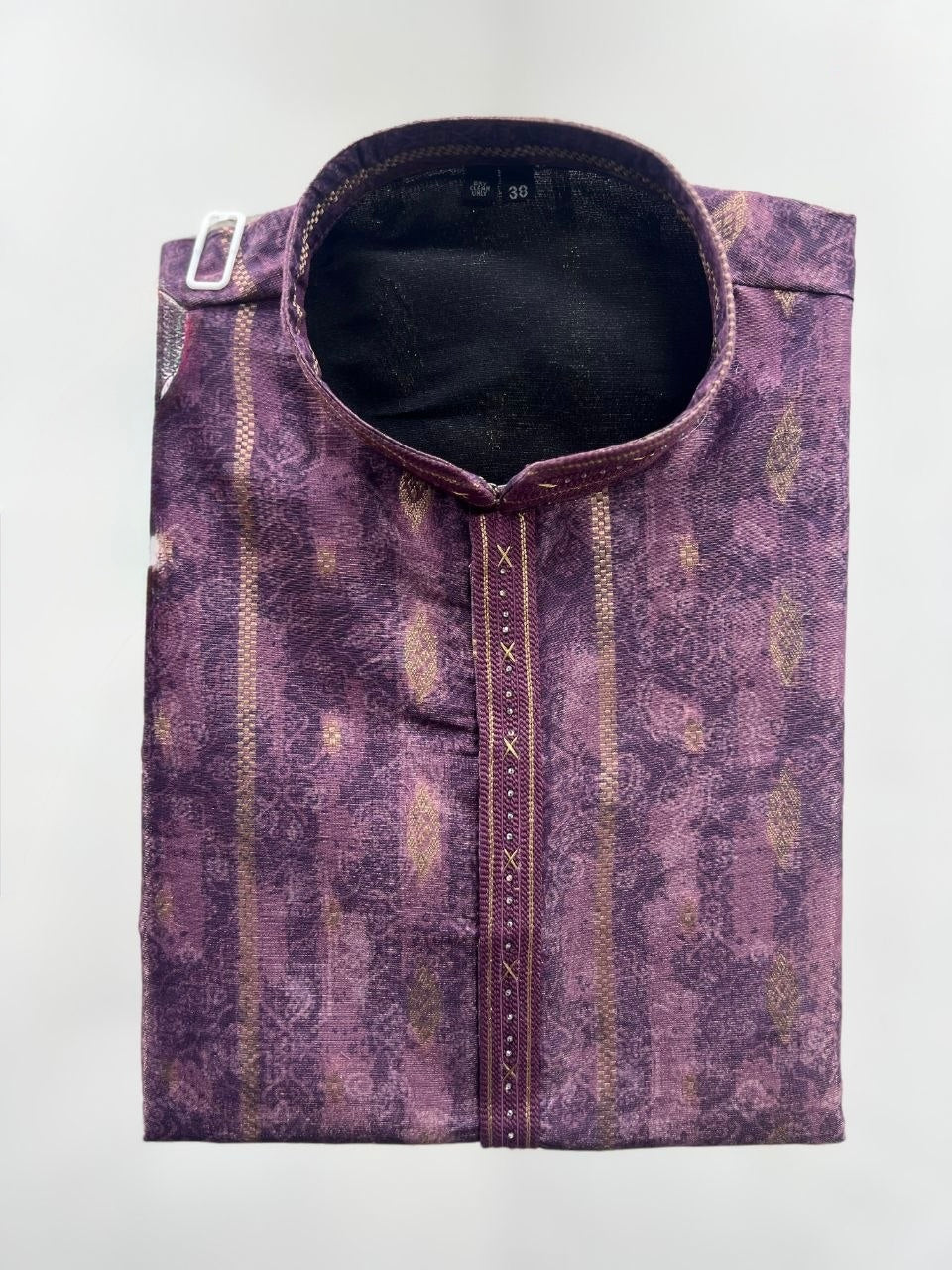 A folded purple patterned kurta with a mandarin collar, featuring vertical gold and beige stripes, a central decorative button placket, and a silver metal belt buckle on the side, shown against a plain light gray background.
