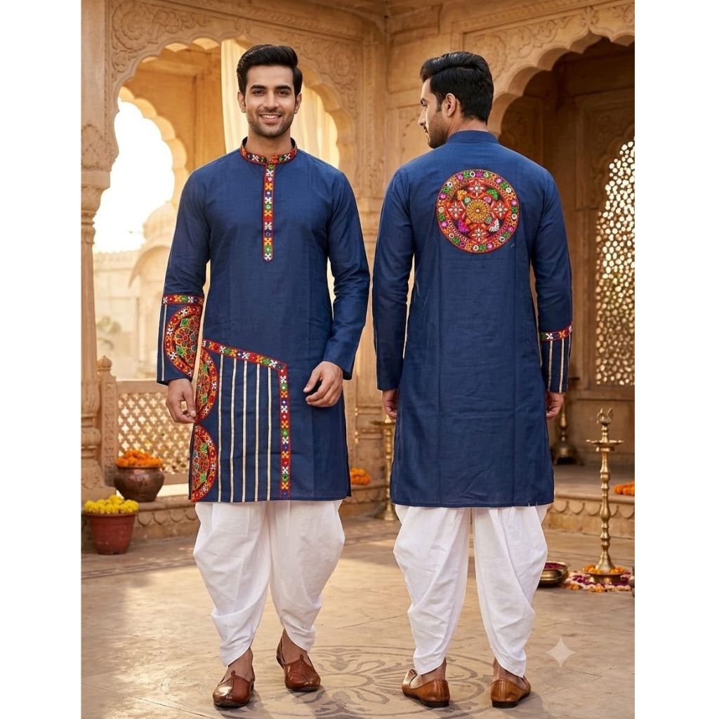 A man modeling a navy blue kurta with colorful embroidered details, shown from both the front and back views, paired with white dhoti pants and brown shoes in an ornate courtyard setting.