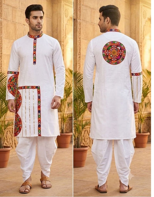 Load image into Gallery viewer, A man modeling a white traditional Indian kurta set with colorful embroidered details, shown in front and back views against a warm architectural background with potted plants.
