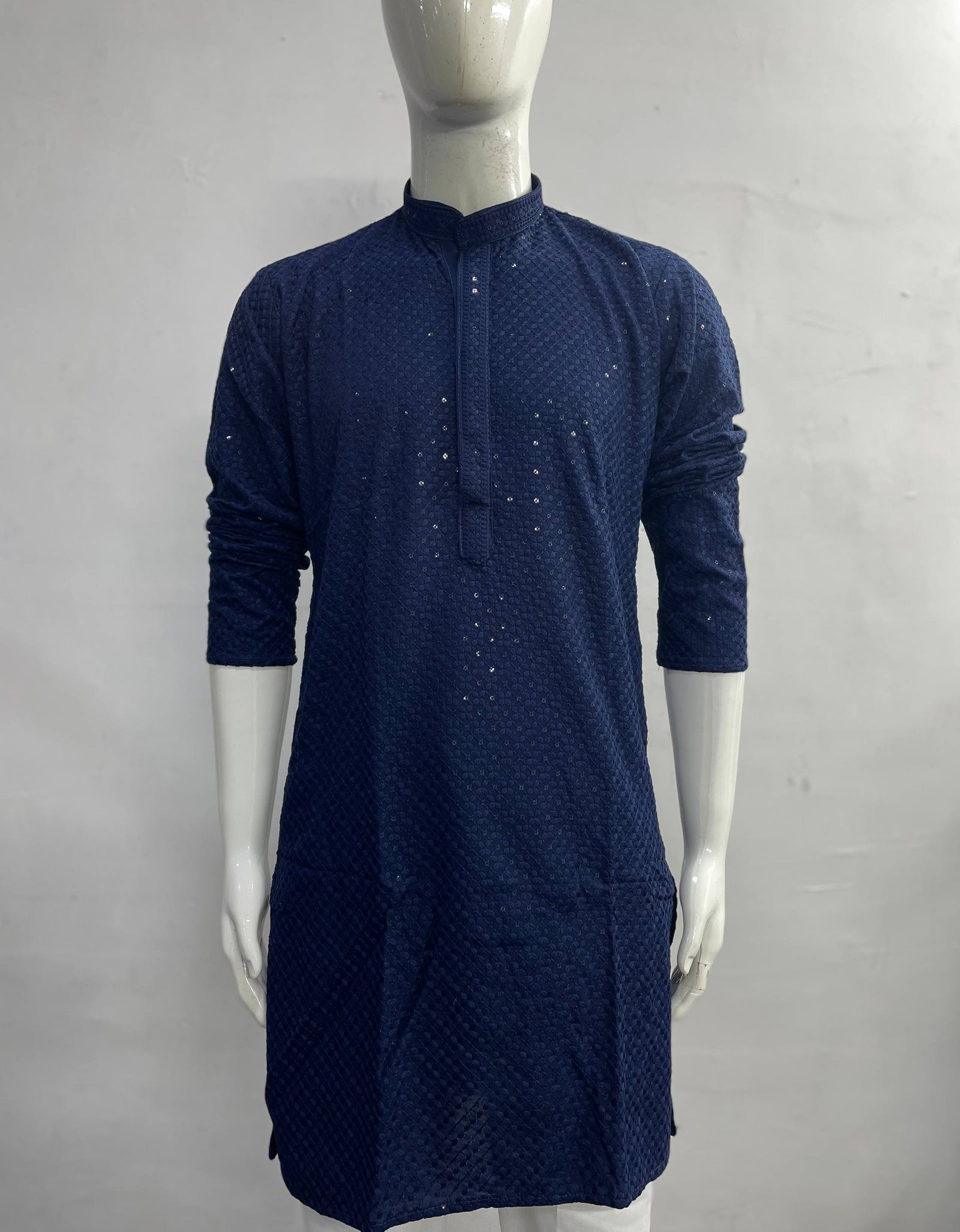 A dark navy blue long-sleeve kurta with a textured dotted pattern and small metallic embellishments, displayed on a white mannequin against a light gray background.