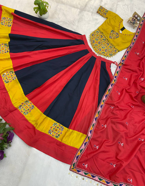 Load image into Gallery viewer, A women's traditional outfit laid flat on a white fabric surface, featuring a red and navy striped skirt with yellow border panels and embroidered details, a matching red dupatta with multicolor geometric trim, and a yellow embroidered blouse.
