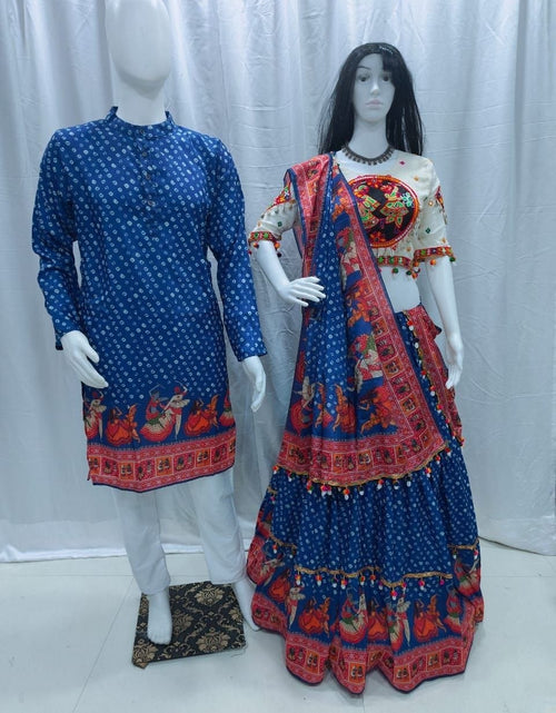 Load image into Gallery viewer, A traditional Indian outfit displayed on two mannequins against a white curtain backdrop. The mannequin on the left wears a blue kurta with white motifs and a red border print, paired with white trousers.
