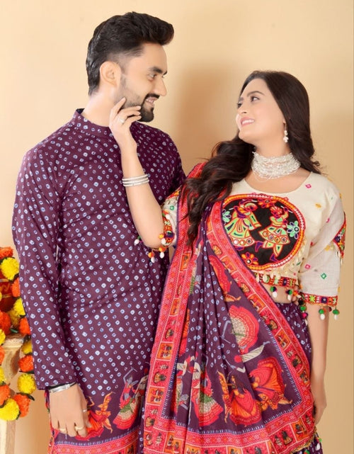 Load image into Gallery viewer, A couple wearing traditional South Asian clothing, featuring a man in a purple patterned kurta and a woman in a matching purple and red printed saree with a cream embroidered blouse, set against a plain beige background.
