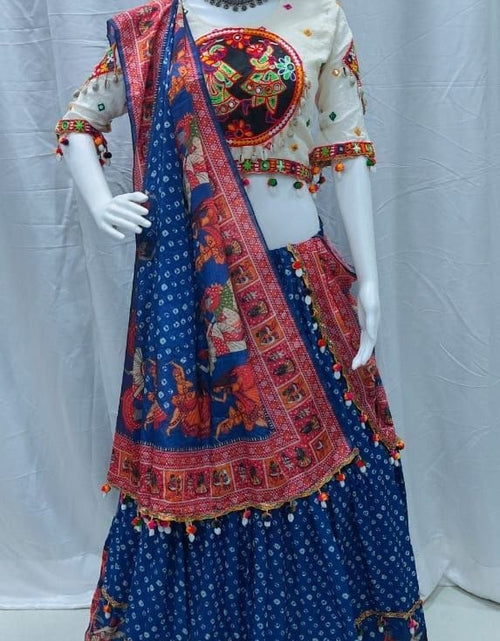 Load image into Gallery viewer, A traditional Indian lehenga choli set displayed on a white mannequin. The set features a deep blue skirt with red and gold border prints, a cream-colored blouse with a large red and gold circular motif on the chest, and a matching blue dupatta with red and gold borders.
