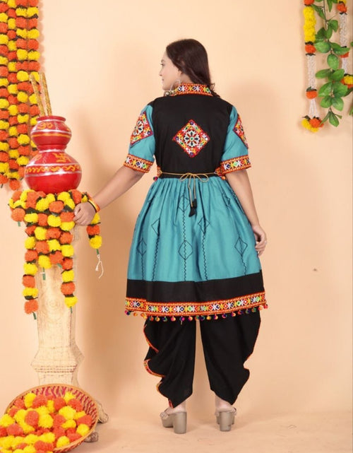 Load image into Gallery viewer, A woman wearing a traditional Indian Navratri kurta and dhoti pants set, shown from the back. The kurta is turquoise blue with a black yoke and colorful embroidered borders, paired with black dhoti pants.
